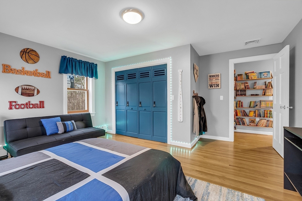 79 Tyler Road Townsend, MA 01469 - Photo 29 of 41 a bedroom with a bed and a wooden floor