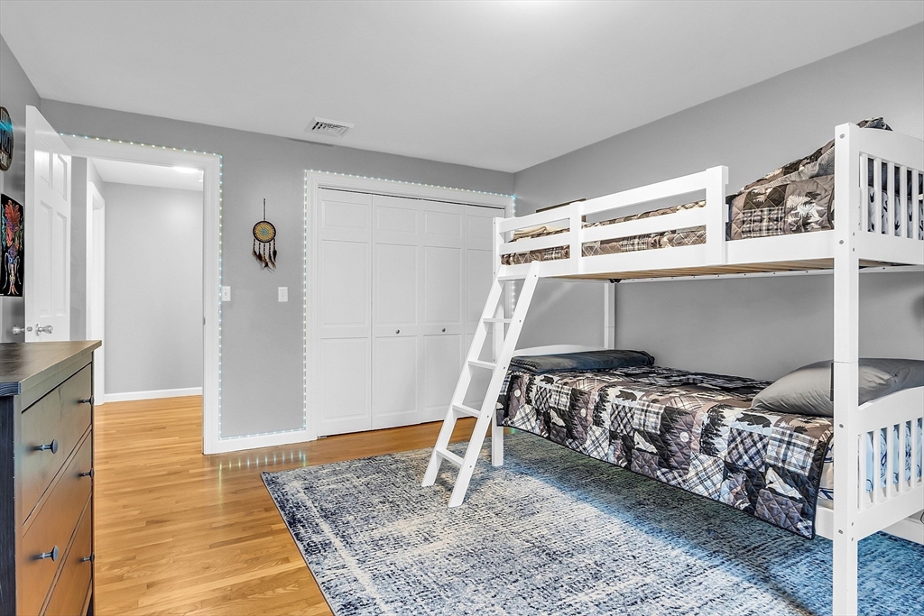 79 Tyler Road Townsend, MA 01469 - Photo 31 of 41 a bedroom with a bed and wooden floor