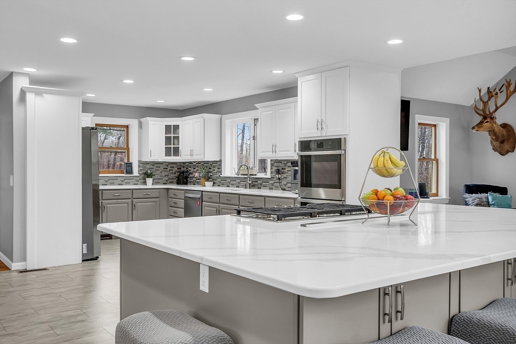 79 Tyler Road Townsend, MA 01469 - Photo 4 of 41 a kitchen with stainless steel appliances granite countertop a sink refrigerator and cabinets