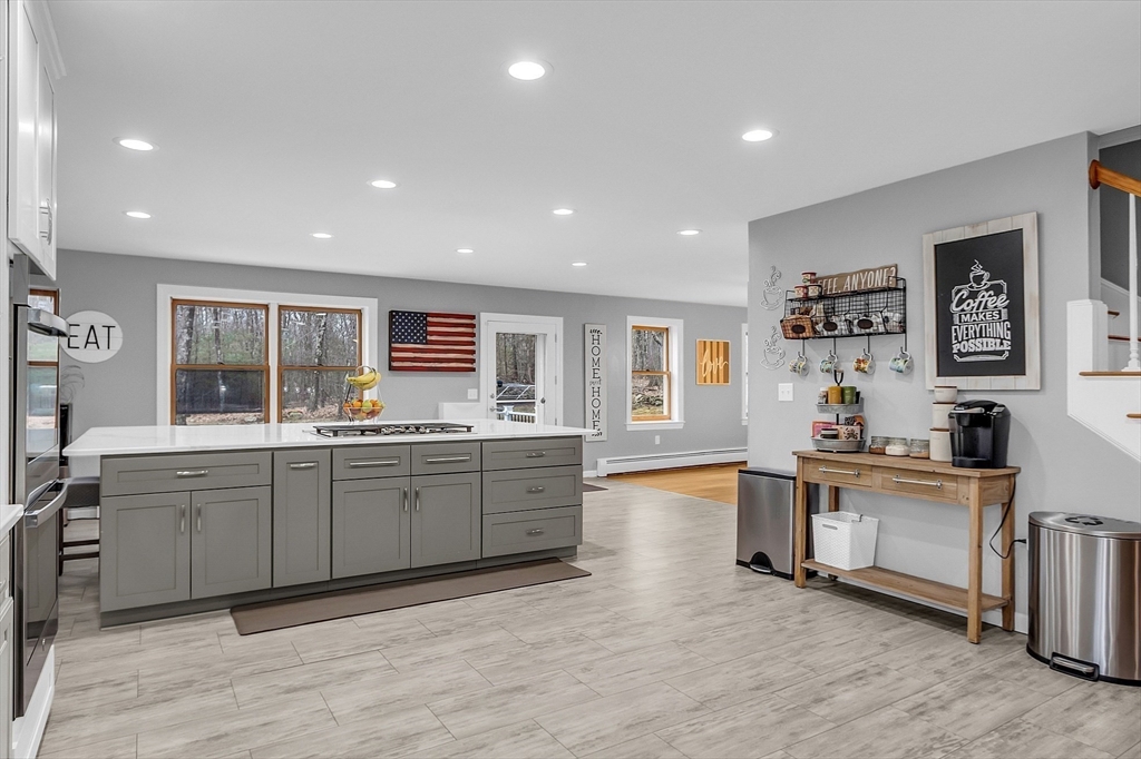 79 Tyler Road Townsend, MA 01469 - Photo 6 of 41 a large kitchen with stainless steel appliances granite countertop a large center island and a sink
