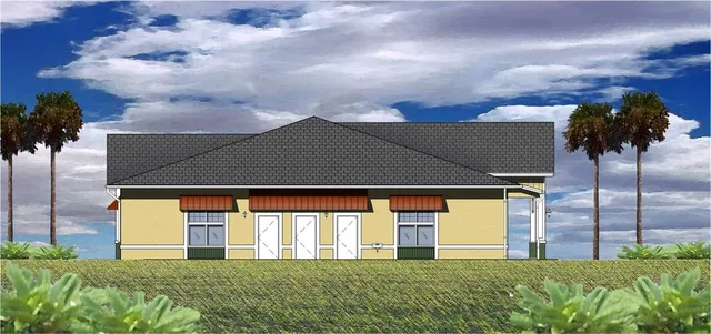 a front view of house with yard and trees in the background