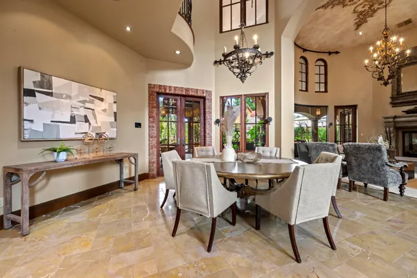 a living room with fireplace furniture and a large window