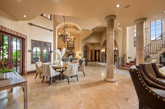 a living room with furniture a large window and a rug