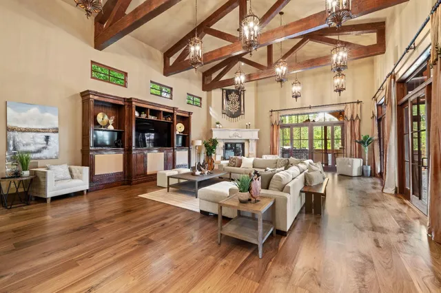 a spacious bedroom with a bed and a flat screen tv