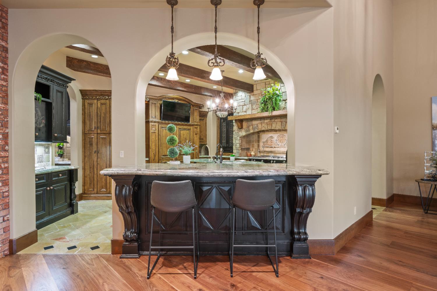 9345 King Road Loomis, CA 95650 - Photo 22 of 99 a dining room with wooden floor a chandelier a wooden table and chairs