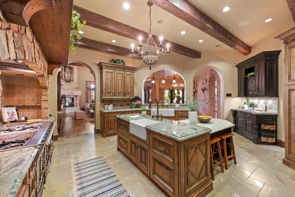 a bathroom with a granite countertop sink a mirror and shower
