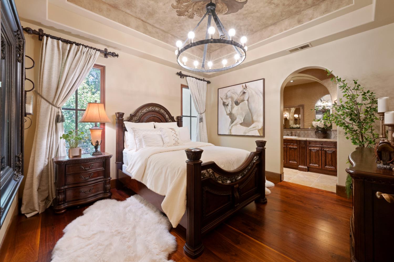 9345 King Road Loomis, CA 95650 - Photo 28 of 99 a bedroom with a bed and a chandelier