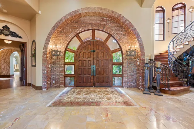 a dining room with furniture and a large window