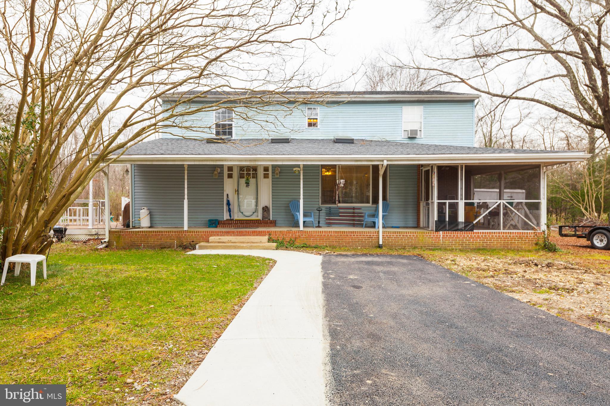 a view of a house with swimming pool and a porch with furniture