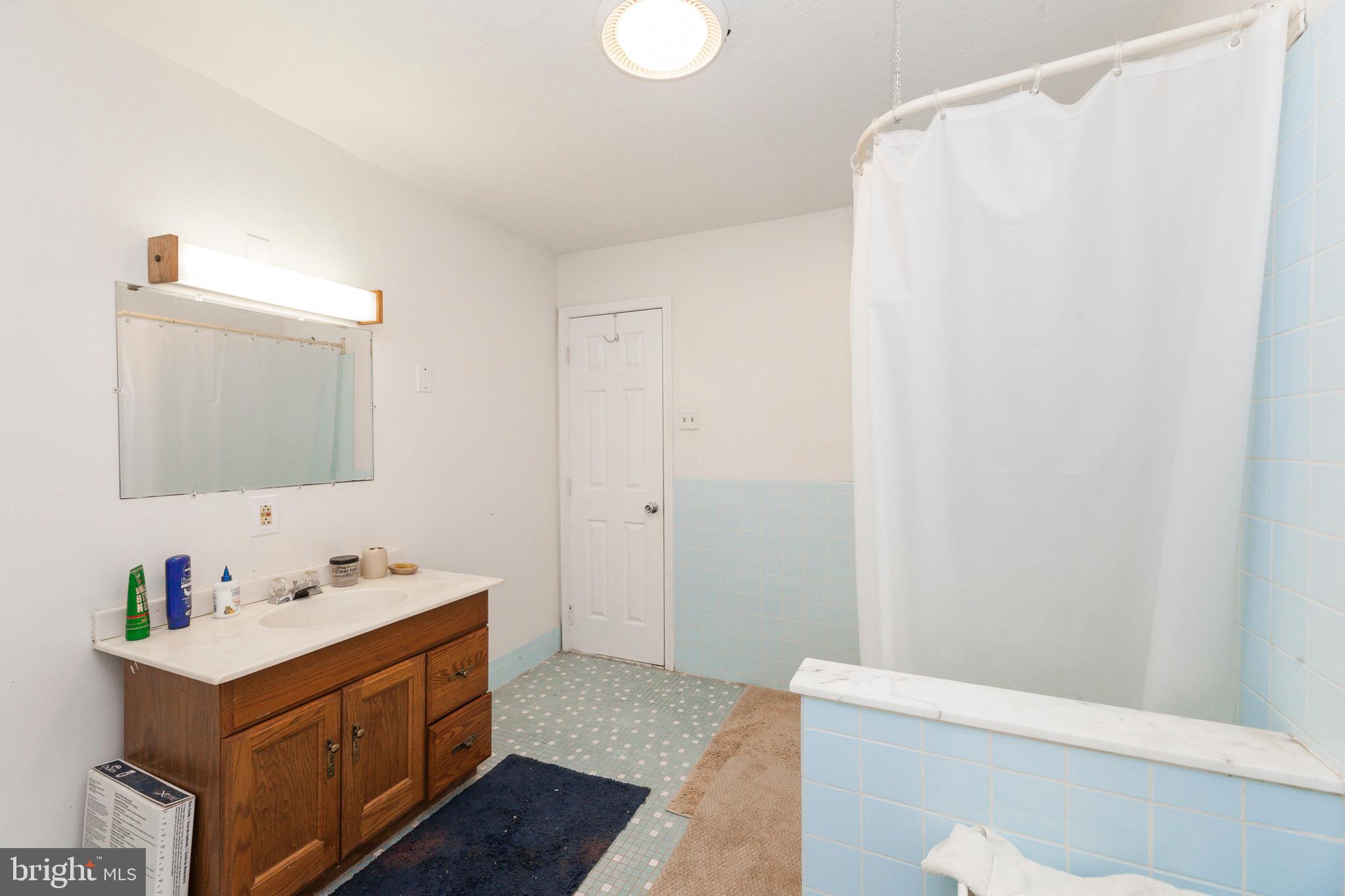 16000 Stone Foot Road Accokeek, MD 20607 - Photo 12 of 45 a bathroom with a sink vanity and a mirror