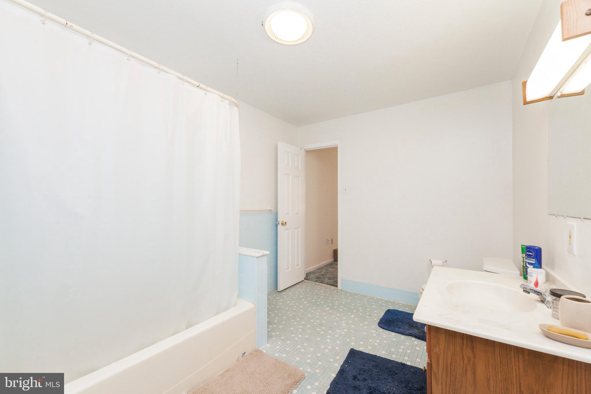 16000 Stone Foot Road Accokeek, MD 20607 - Photo 25 of 45 a bathroom with a sink and a mirror