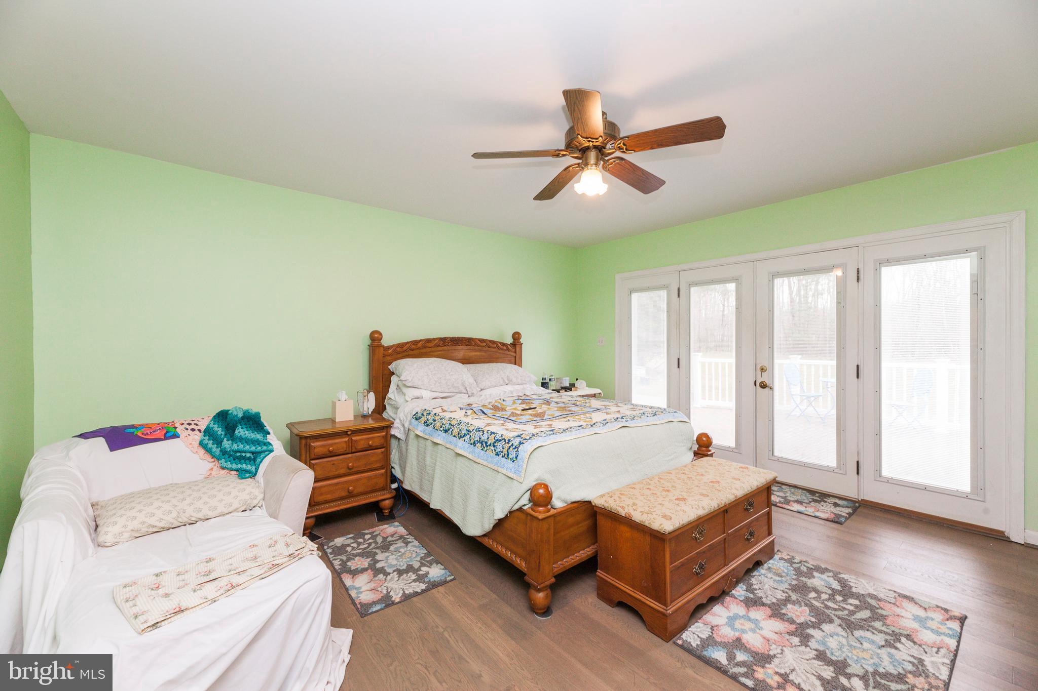 16000 Stone Foot Road Accokeek, MD 20607 - Photo 4 of 45 a bedroom with a bed and wooden floor