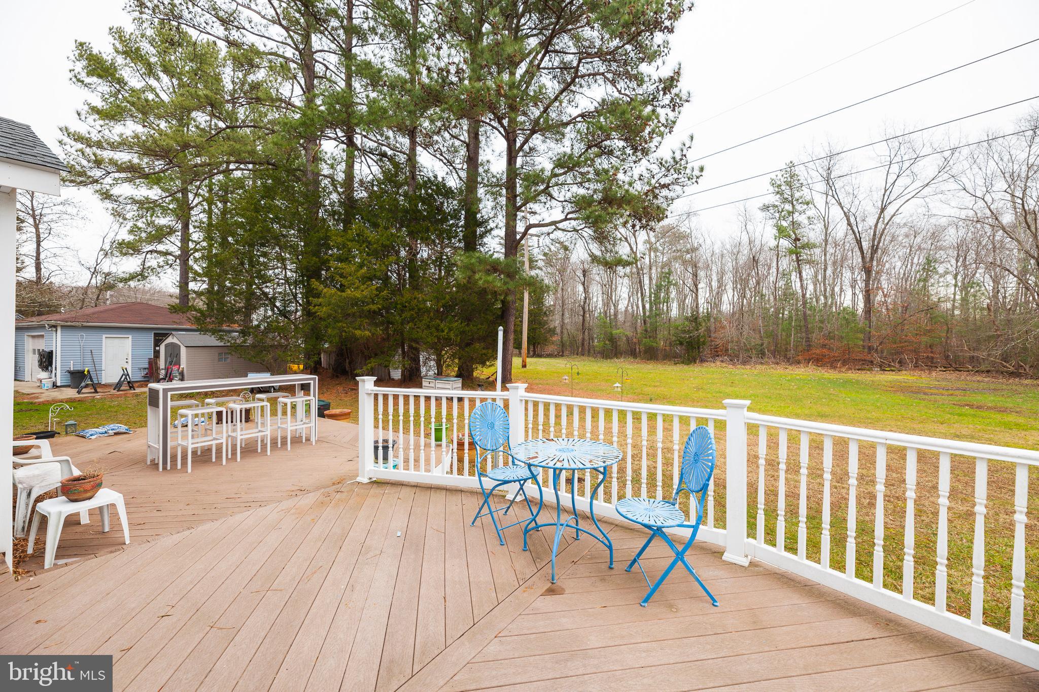 16000 Stone Foot Road Accokeek, MD 20607 - Photo 38 of 45 a view of a balcony with wooden floor and outdoor seating
