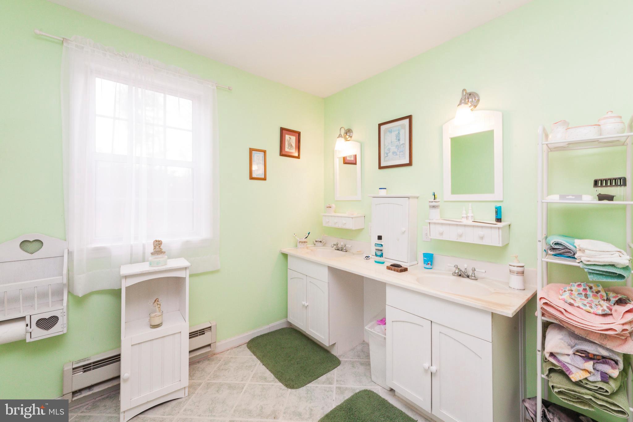 16000 Stone Foot Road Accokeek, MD 20607 - Photo 10 of 45 a bathroom with a sink mirror vanity and toilet