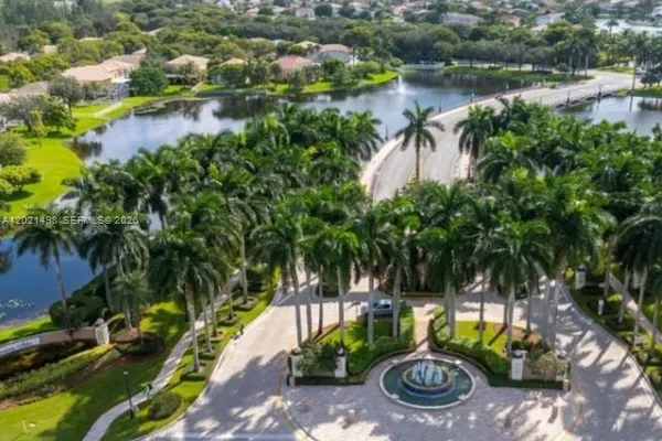 a backyard of a house with lots of green space and lake view
