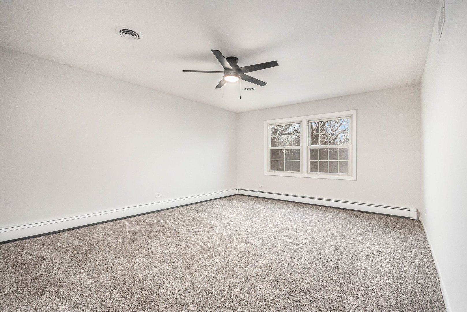 323 Chicago Road Oswego, IL 60543 - Photo 11 of 27 an empty room with windows and ceiling fan view