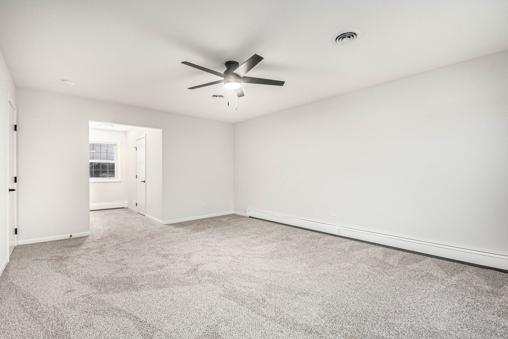 323 Chicago Road Oswego, IL 60543 - Photo 12 of 27 an empty room with a empty space and a ceiling fan