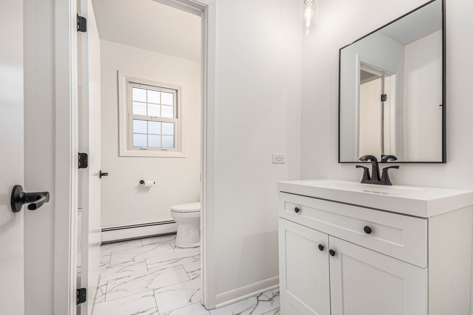 323 Chicago Road Oswego, IL 60543 - Photo 13 of 27 a bathroom with a sink a toilet and a mirror