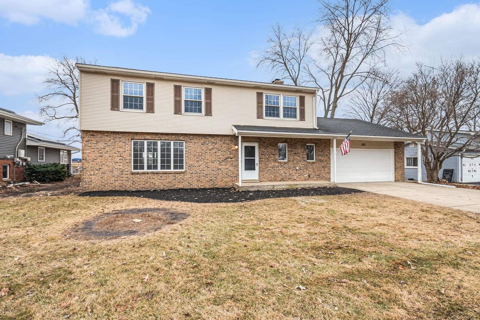 323 Chicago Road Oswego, IL 60543 - Photo 2 of 27 a front view of a house with a yard