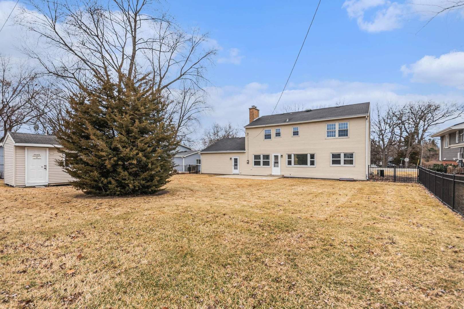 323 Chicago Road Oswego, IL 60543 - Photo 23 of 27 a large house with a large tree in front of it
