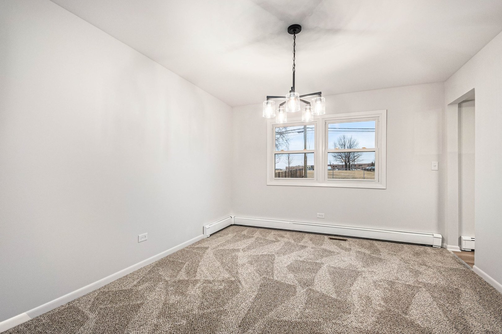 323 Chicago Road Oswego, IL 60543 - Photo 5 of 27 a view of wooden floor and window in a room