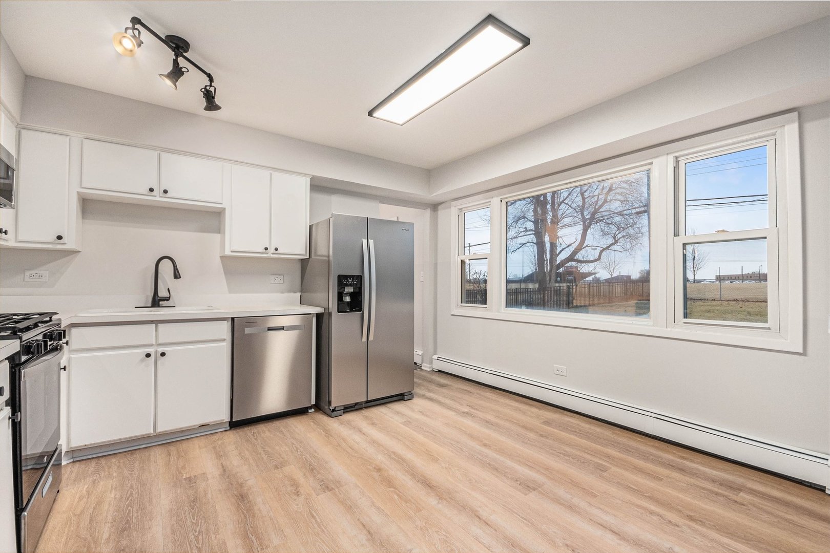 323 Chicago Road Oswego, IL 60543 - Photo 8 of 27 a kitchen with stainless steel appliances a refrigerator sink and cabinets