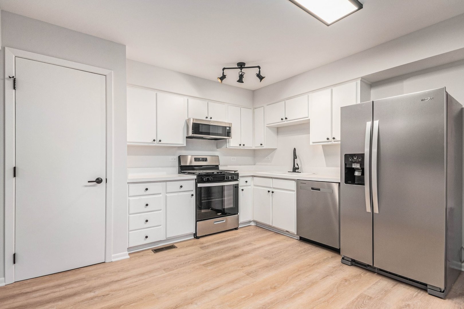 323 Chicago Road Oswego, IL 60543 - Photo 9 of 27 a kitchen with stainless steel appliances a refrigerator sink and cabinets