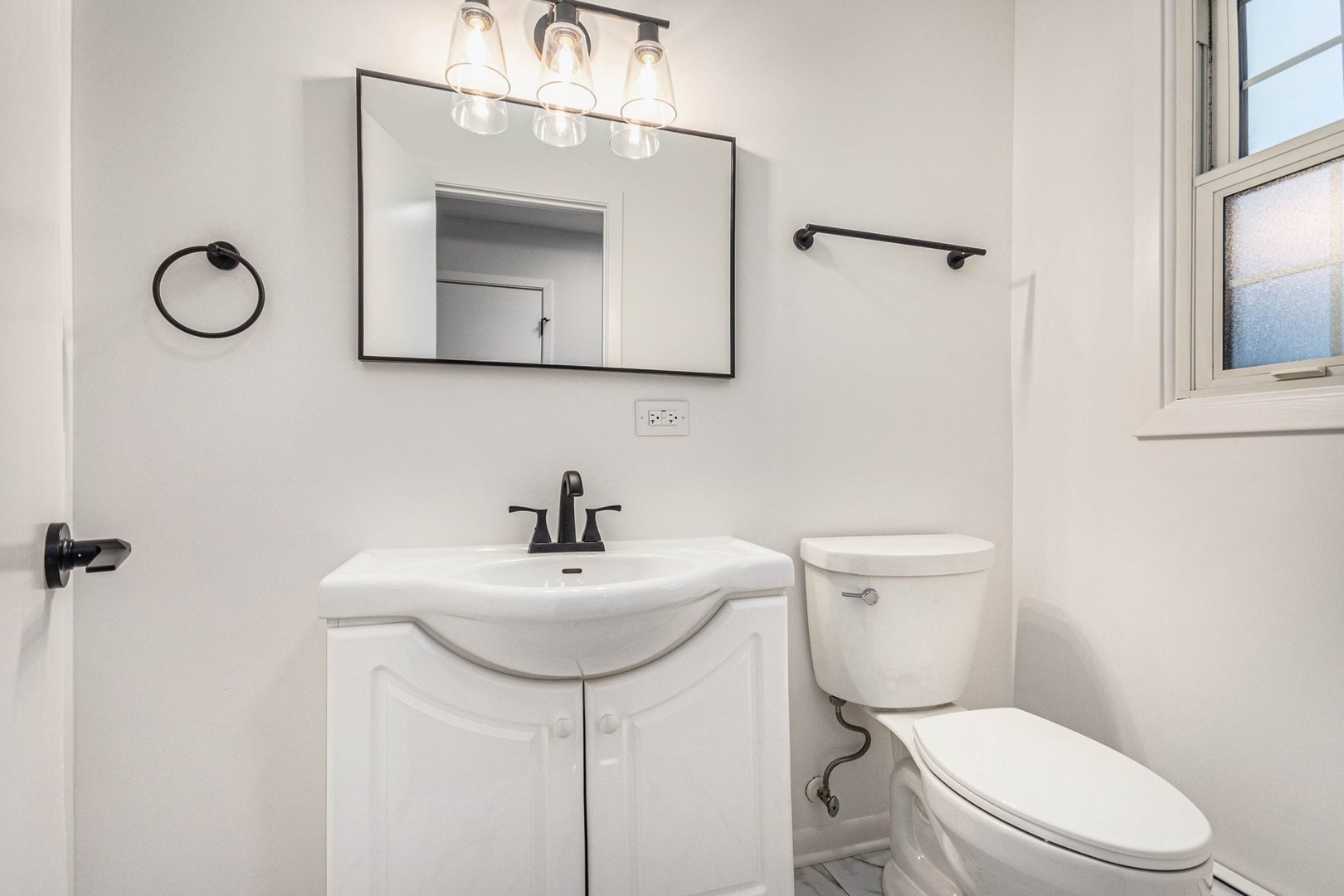 323 Chicago Road Oswego, IL 60543 - Photo 10 of 27 a bathroom with a toilet sink and mirror