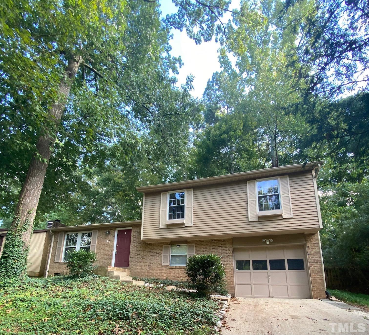 7317 Shellburne Drive Raleigh, NC 27612 - Photo 1 of 28 a front view of a house with garden