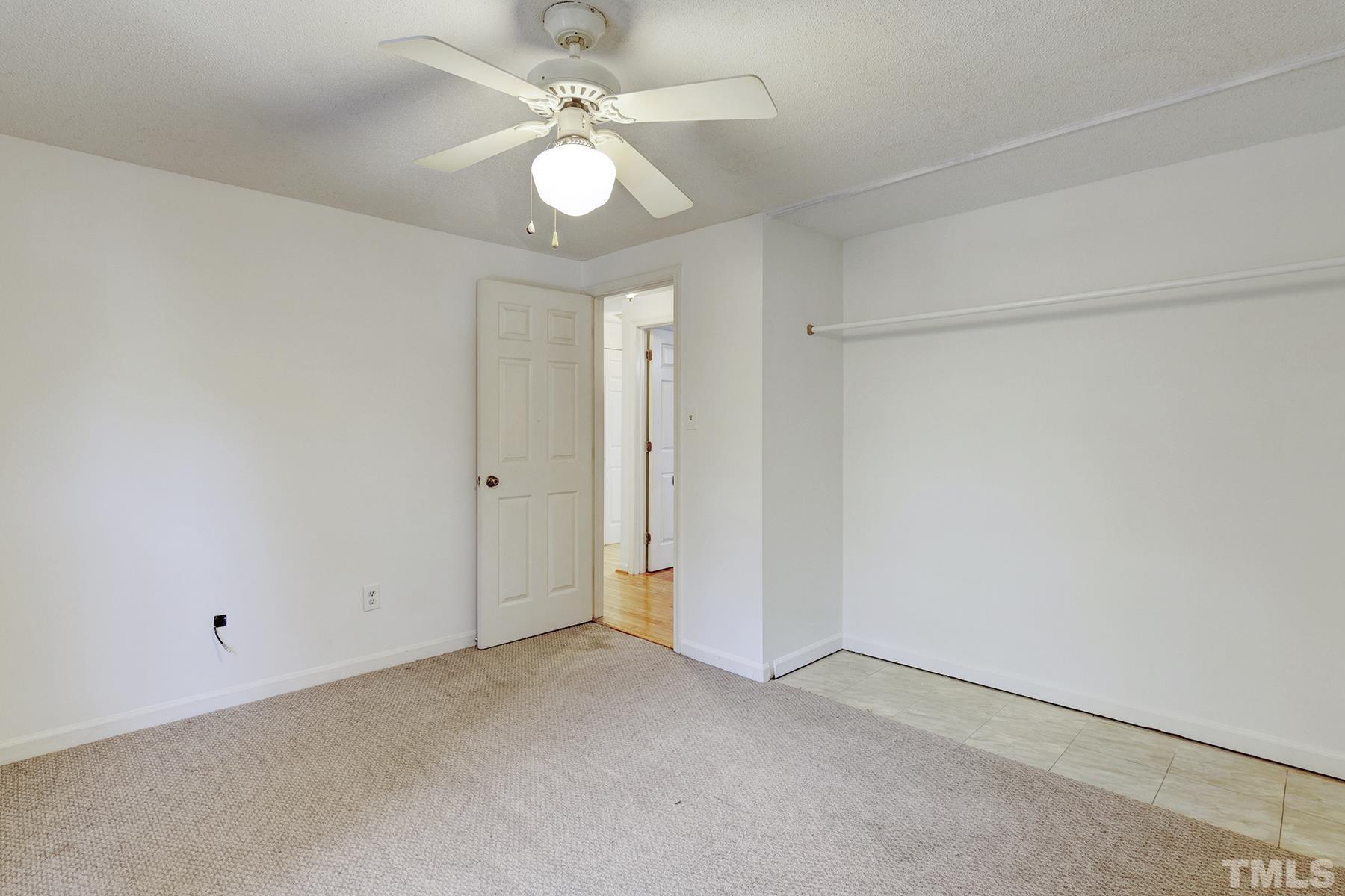 7317 Shellburne Drive Raleigh, NC 27612 - Photo 13 of 28 an empty room with a ceiling fan and a window