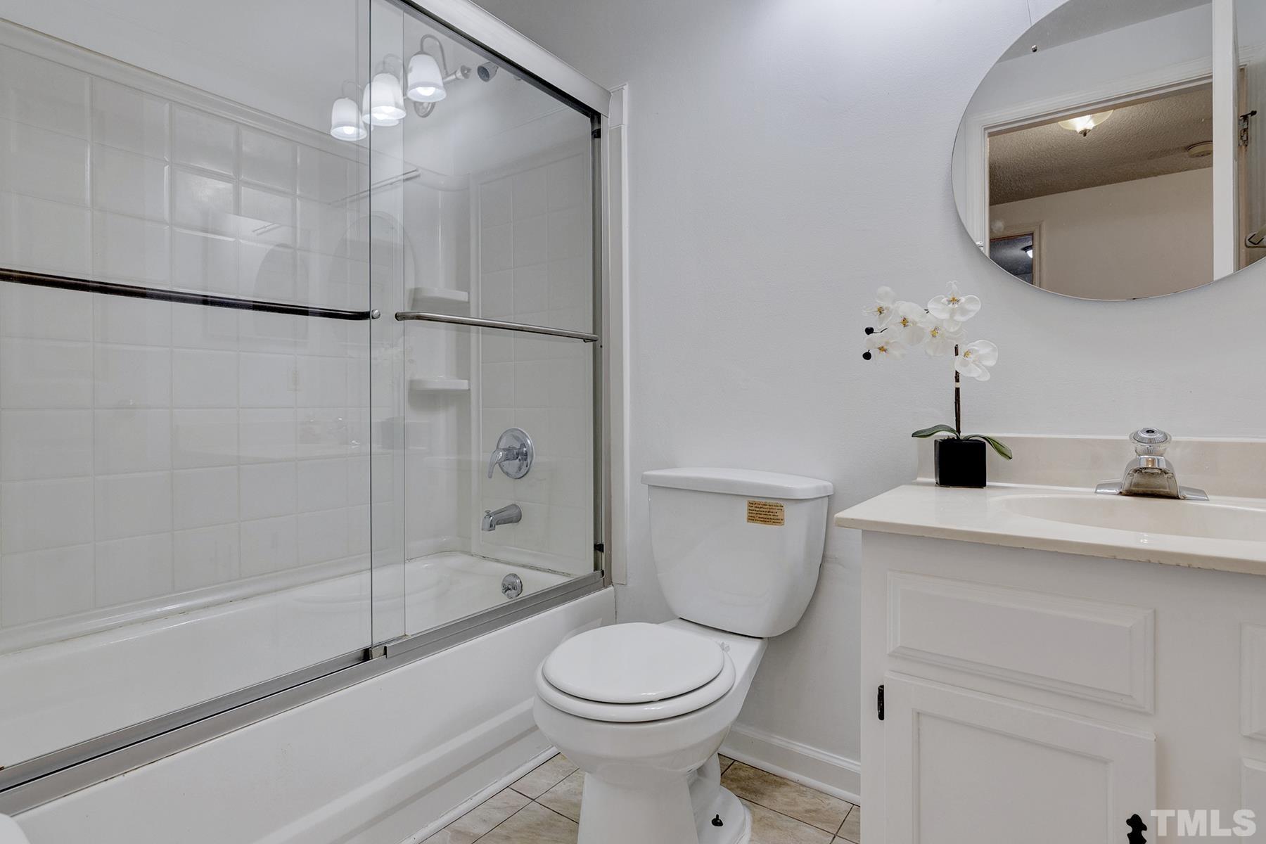 7317 Shellburne Drive Raleigh, NC 27612 - Photo 14 of 28 a bathroom with a sink a toilet and shower