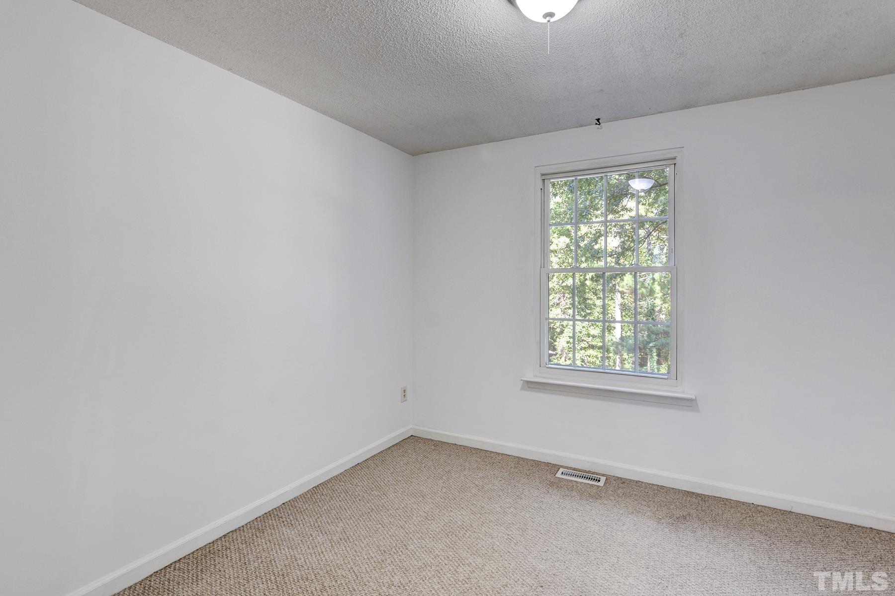 7317 Shellburne Drive Raleigh, NC 27612 - Photo 16 of 28 an empty room with a window