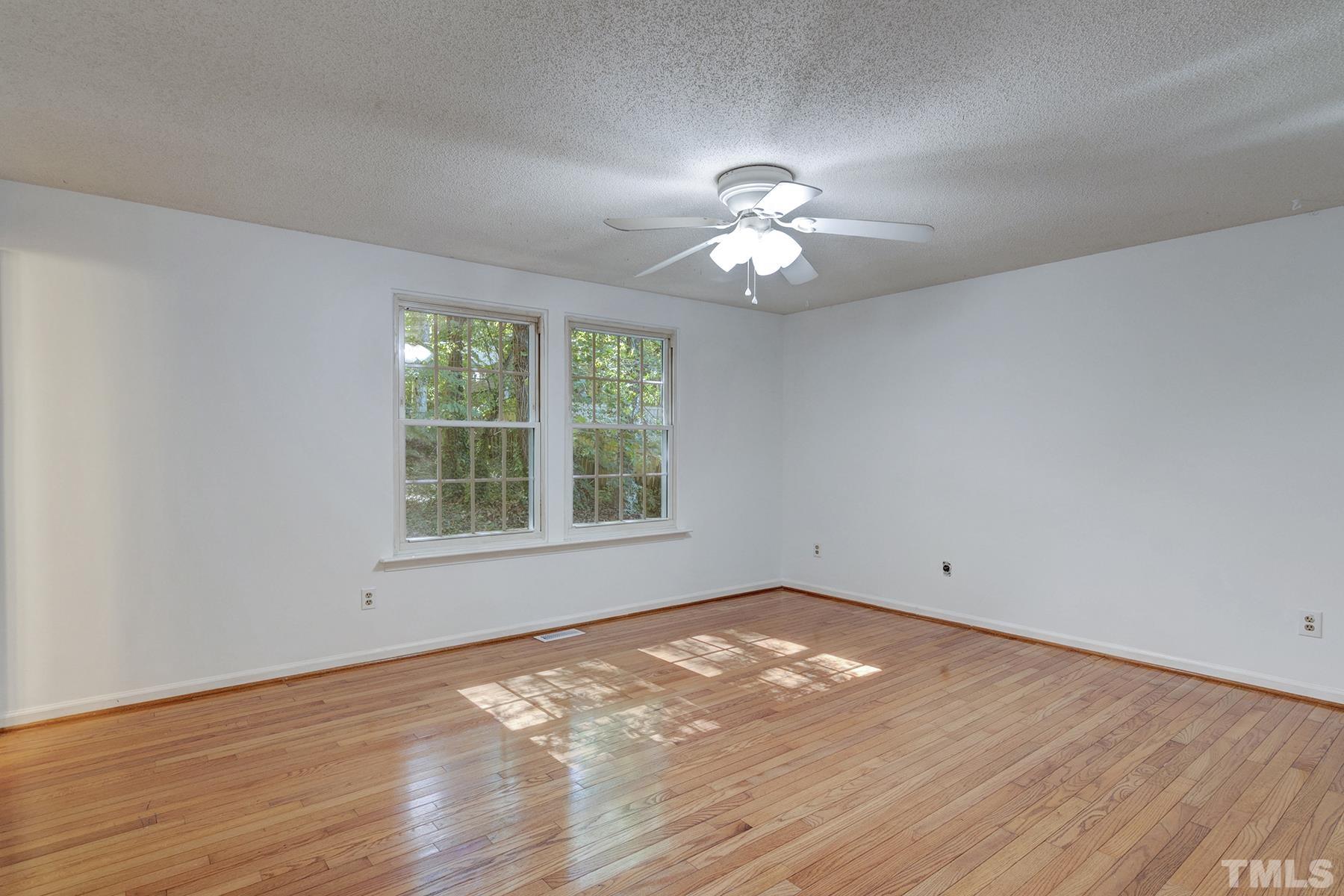 7317 Shellburne Drive Raleigh, NC 27612 - Photo 17 of 28 wooden floor in an empty room with a window
