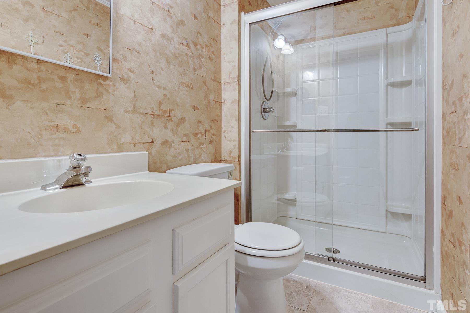 7317 Shellburne Drive Raleigh, NC 27612 - Photo 19 of 28 a bathroom with a sink toilet and shower