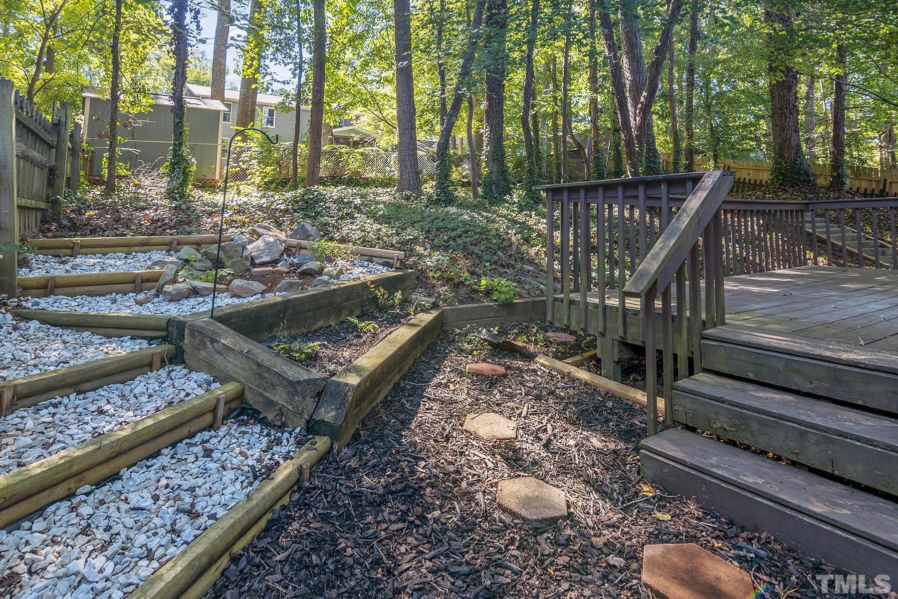 7317 Shellburne Drive Raleigh, NC 27612 - Photo 26 of 28 a view of a wooden deck with chairs and a yard