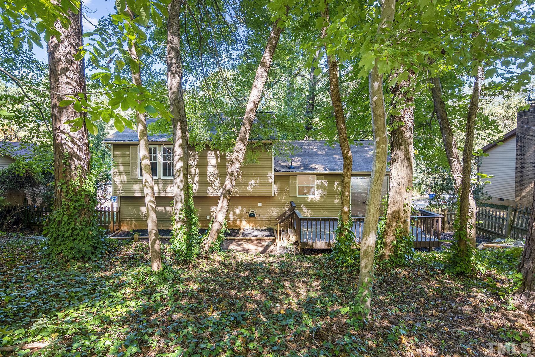 7317 Shellburne Drive Raleigh, NC 27612 - Photo 27 of 28 a view of a patio with table and chairs and potted plants
