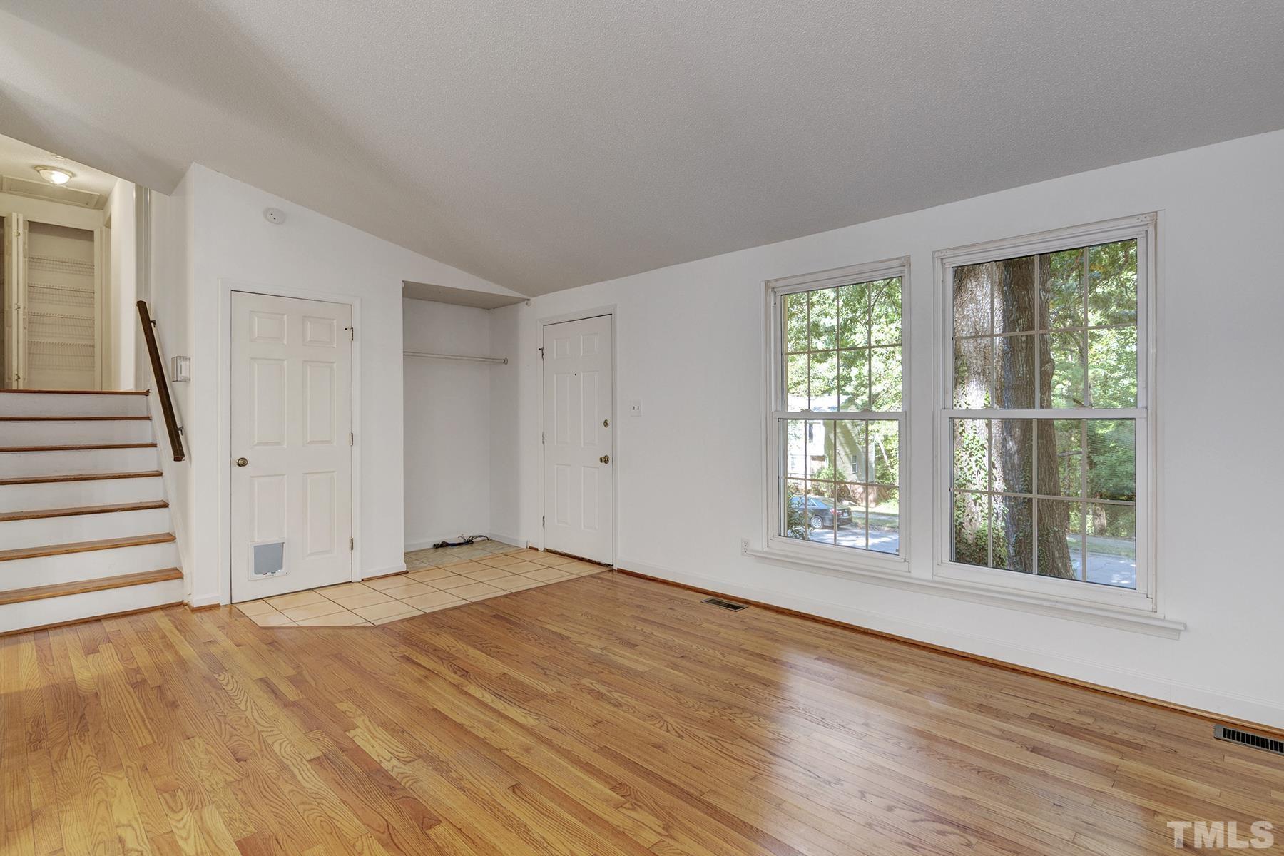 7317 Shellburne Drive Raleigh, NC 27612 - Photo 5 of 28 a view of an empty room with wooden floor and a window