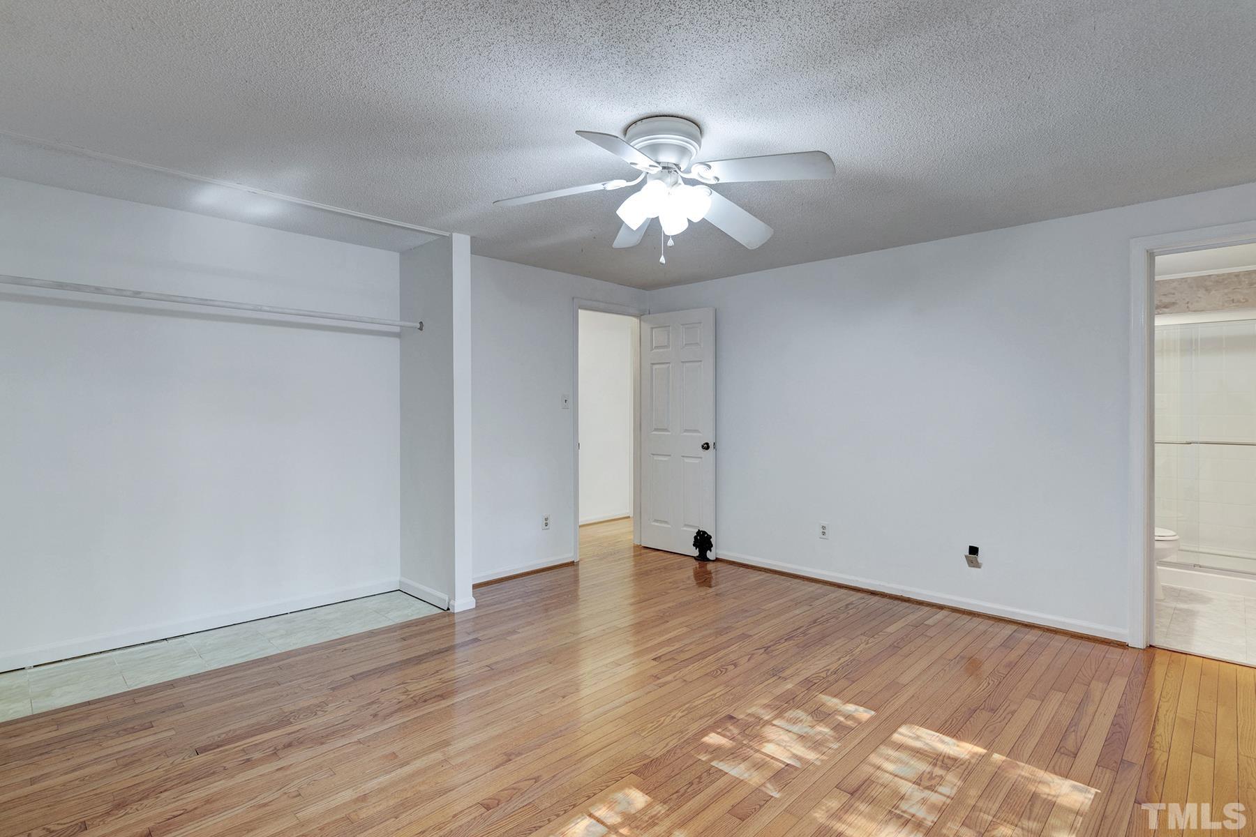 7317 Shellburne Drive Raleigh, NC 27612 - Photo 7 of 28 a view of an empty room with wooden floor