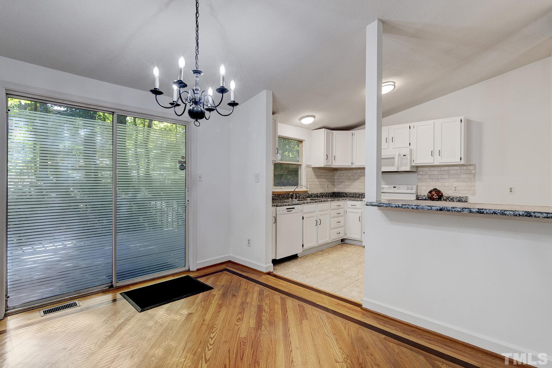 7317 Shellburne Drive Raleigh, NC 27612 - Photo 10 of 28 a view of a kitchen with granite countertop stainless steel appliances and a counter top space