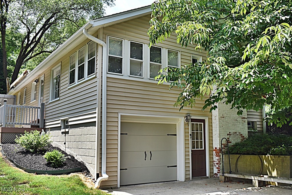 17600 Egbert Road Bedford, OH 44146 - Photo 49 of 49 View of home's exterior featuring a garage, a deck, and driveway
