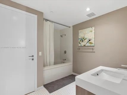 a bathroom with a tub and sink