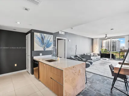a view of a kitchen counter top space and living room