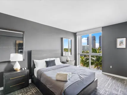 a bedroom with a large bed and a window