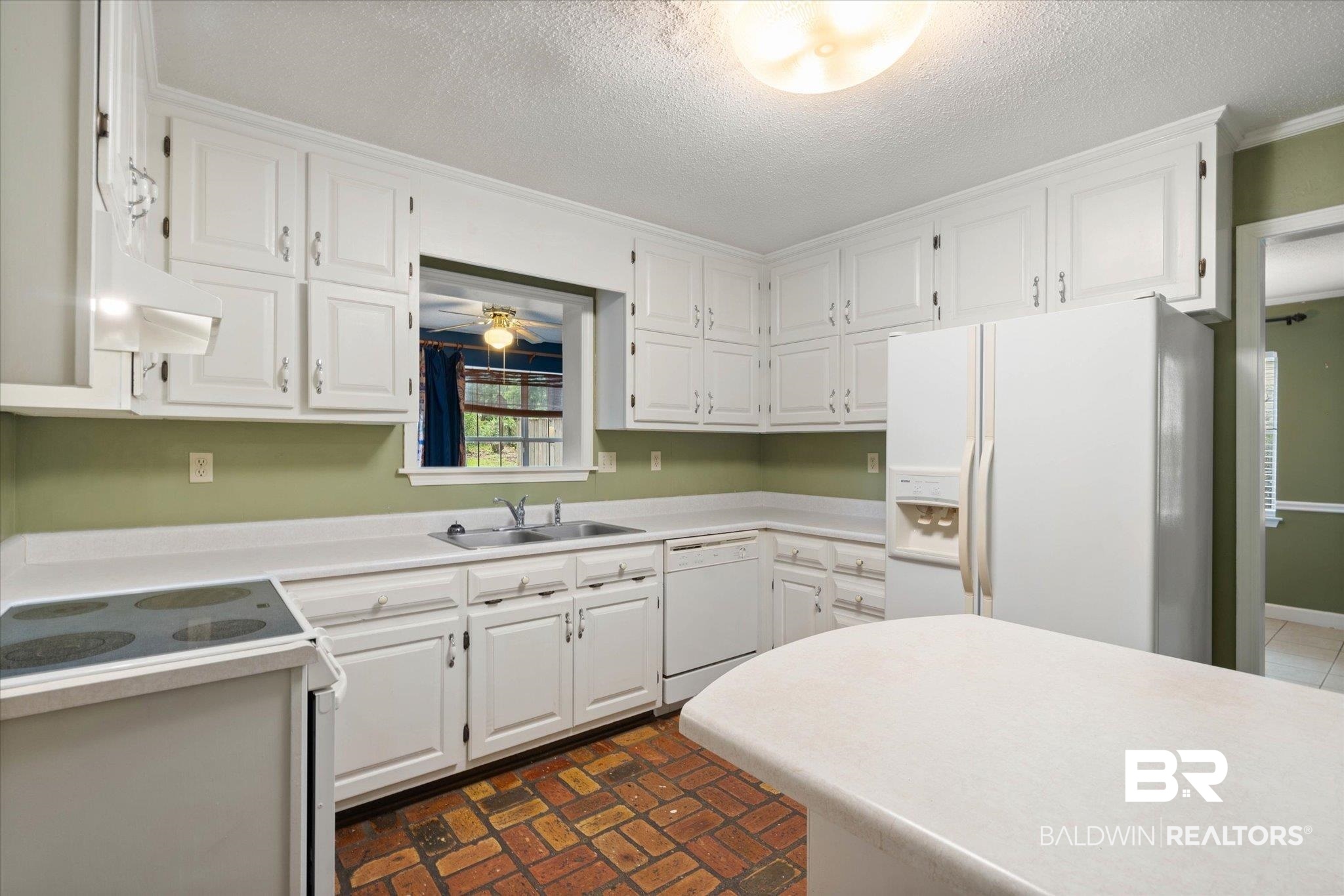 6632 Autumn Ridge Drive Mobile, AL 36695 - Photo 8 of 22 Kitchen featuring white appliances, extractor fan, white cabinets, a textured ceiling, and light countertops