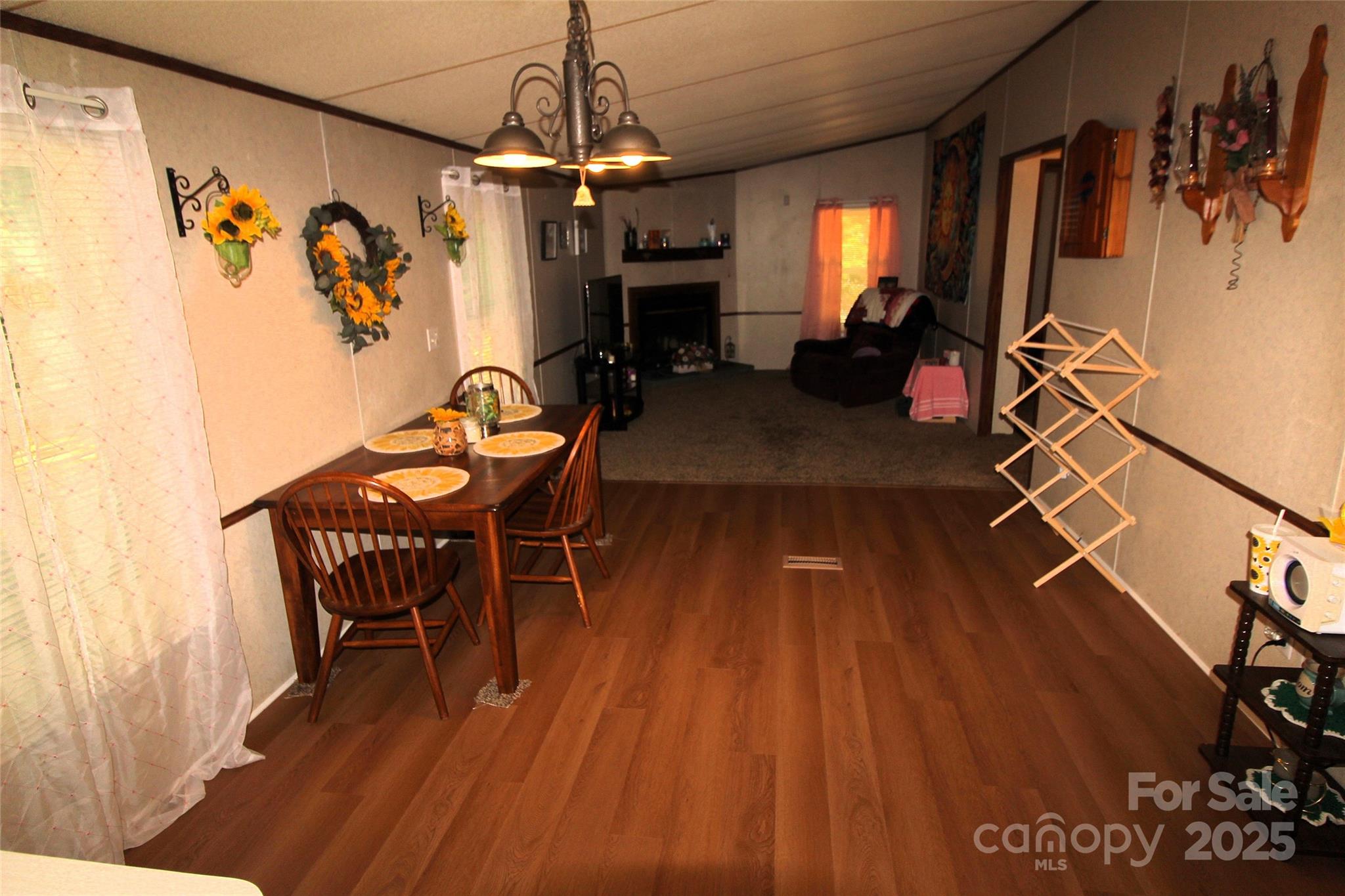7035 Twin Streams Lane Clover, SC 29710 - Photo 8 of 22 a dining room with furniture a chandelier and wooden floor