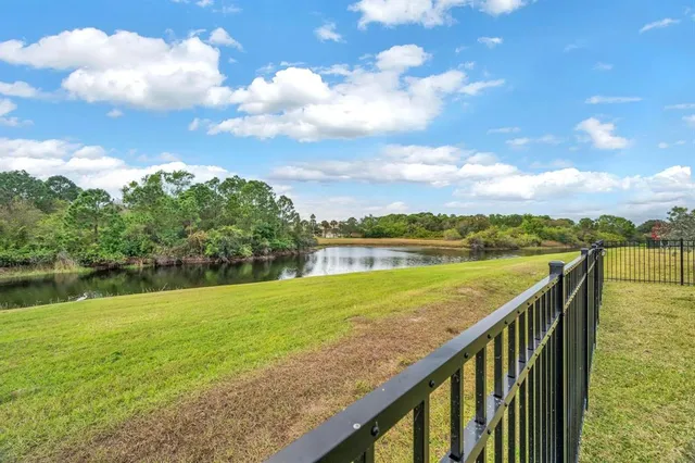 a en suite bathroom with a granite countertop sink and a mirror