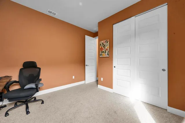 a living room with furniture and kitchen view