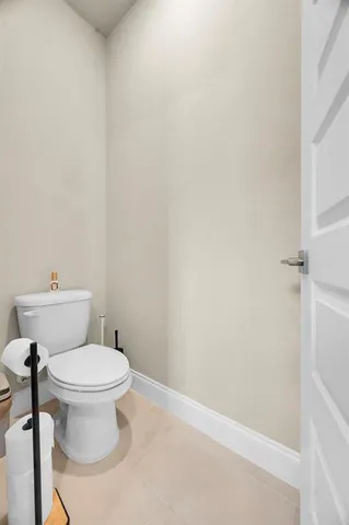 a en suite bathroom with a toilet a sink and mirror