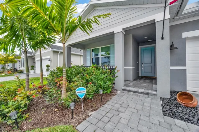 a living room with patio furniture and a floor to ceiling window