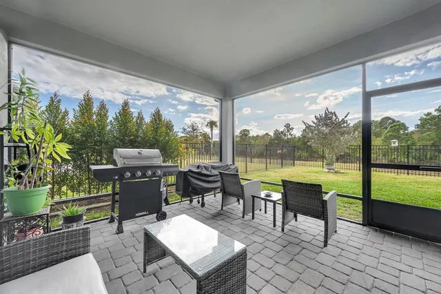 a backyard of a house with table and chairs